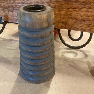 Ribbed wood candle holder.